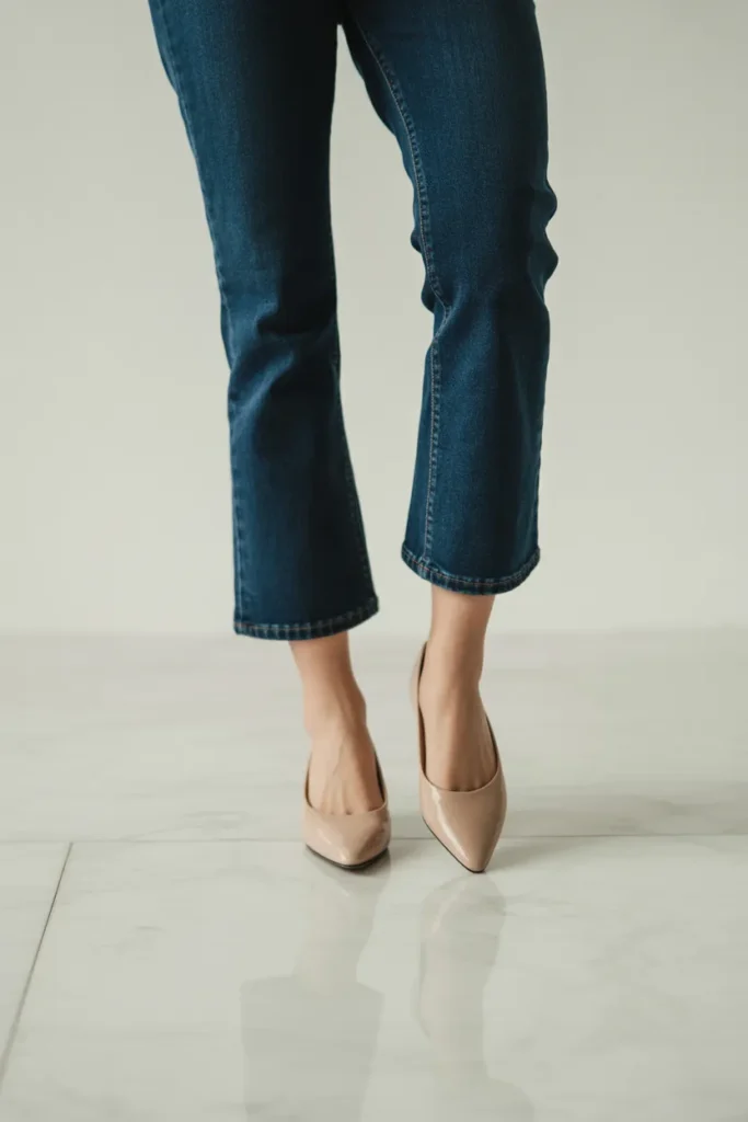 Cropped kick-flare jeans styled with nude ballet flats — flattering capsule wardrobe denim essential for petite styling