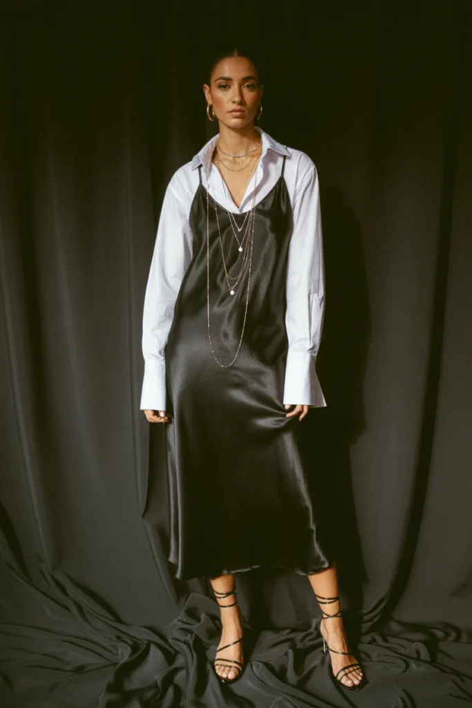 White button-down shirt layered under black slip dress date night outfit styling