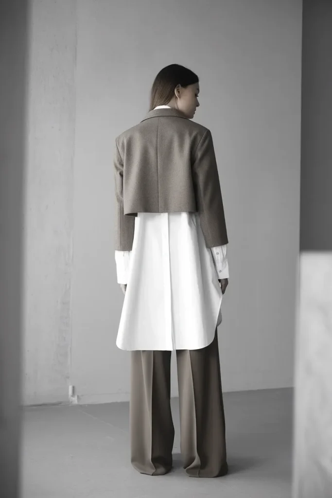 Cropped taupe blazer over a white button-down showing the shrunken jacket trend for fall 2026